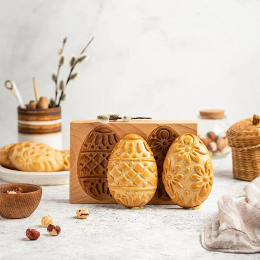 Wooden mold with cookie shapes on a kitchen counter