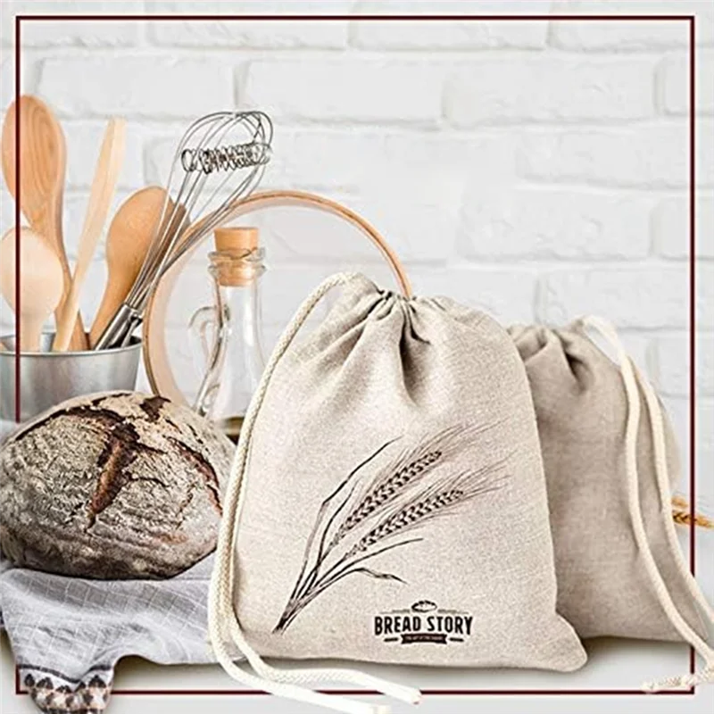 Drawstring bag with 'Bread Story' branding next to a loaf of bread and kitchen utensils on a white brick wall background.