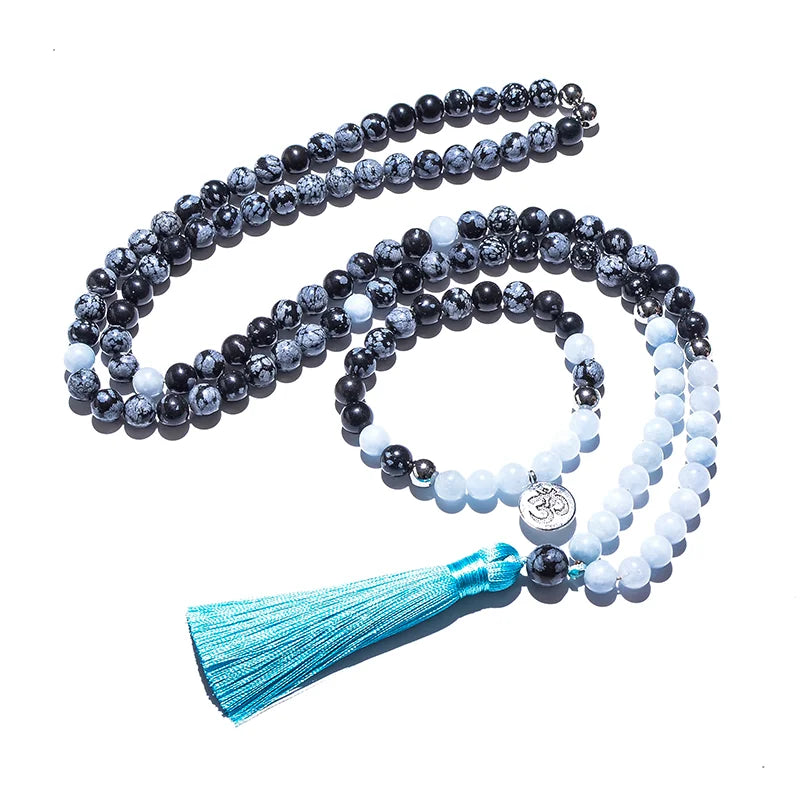 Mala necklace with blue tassel on a white background