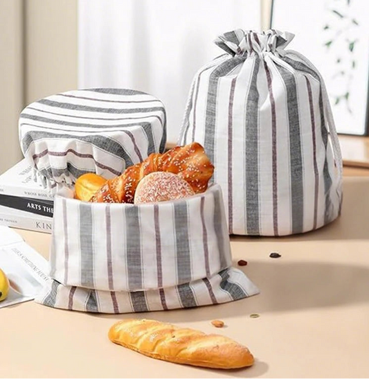 Striped fabric bread basket with bread on a table