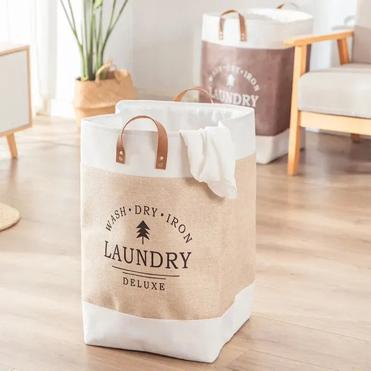 Laundry bag with 'Wash Dry Iron Laundry Deluxe' text on a wooden floor.