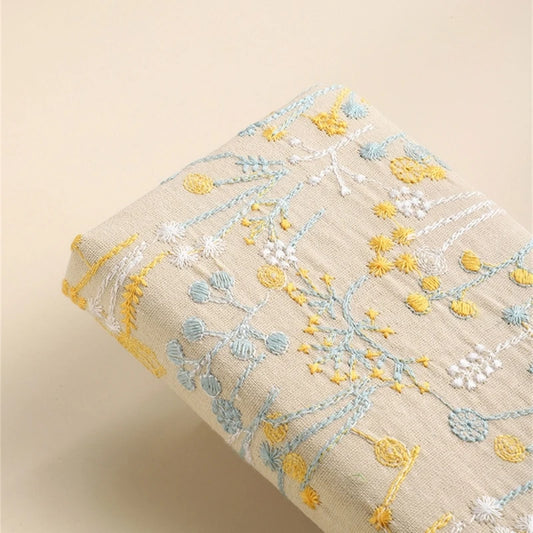 Embroidered fabric with floral patterns on a beige background