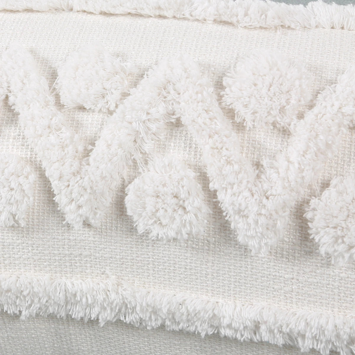 Close-up of a textured white fabric with frayed edges.