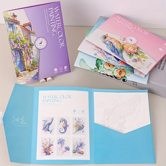 Watercolor painting books and stationery on a light surface