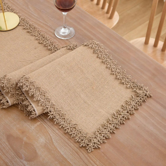 Beige placemats with decorative edges on a wooden table.