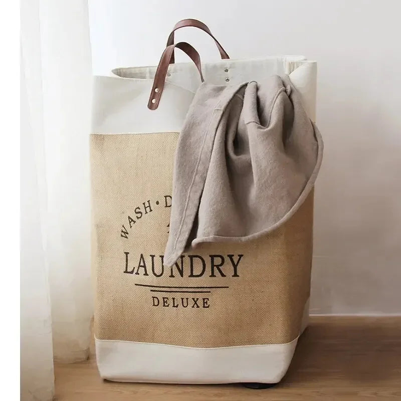Beige laundry bag with 'Wash & Dry Laundry Deluxe' text, containing a gray garment.