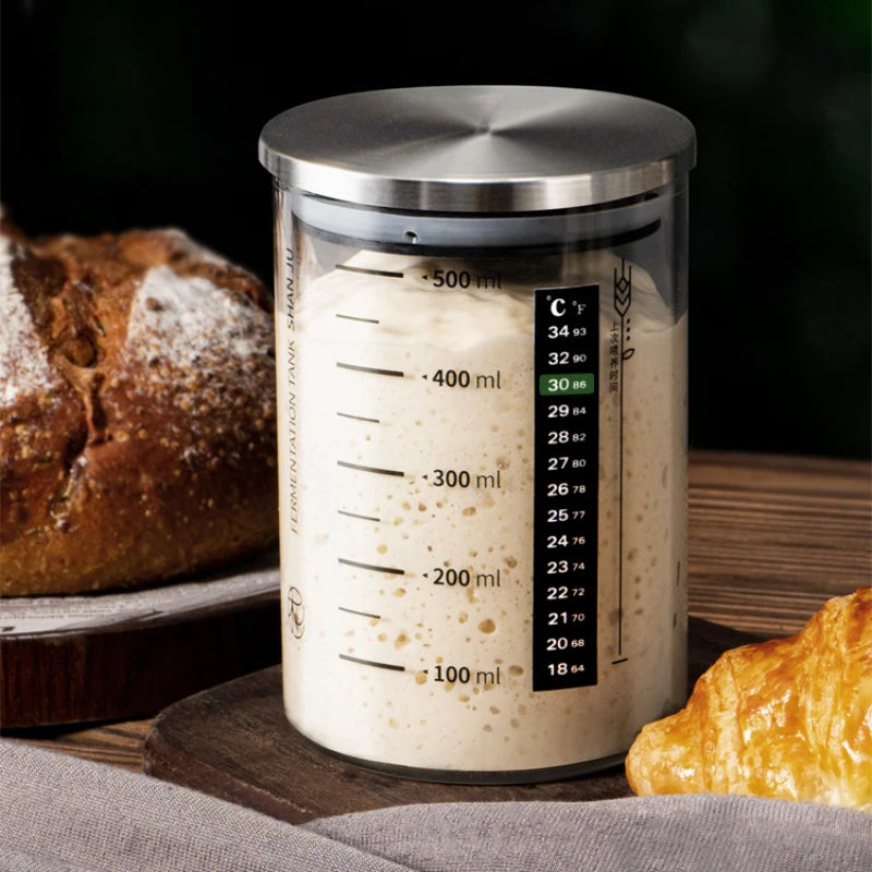 Measuring container with bread and pastries on a wooden surface