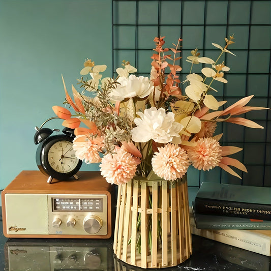 Vase with flowers on a table next to an alarm clock and radio against a checkered wall.