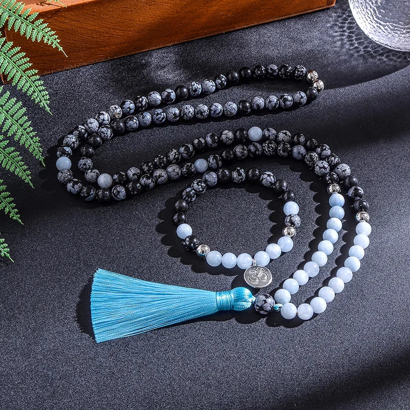 Mala necklace with blue tassel on a dark surface