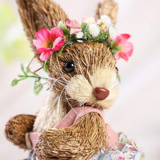 Decorative straw mouse with floral crown on a light background