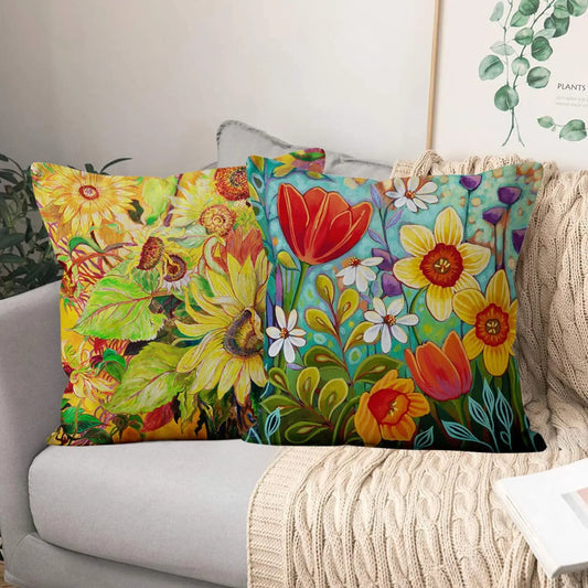 Colorful floral pillows on a couch with a neutral background