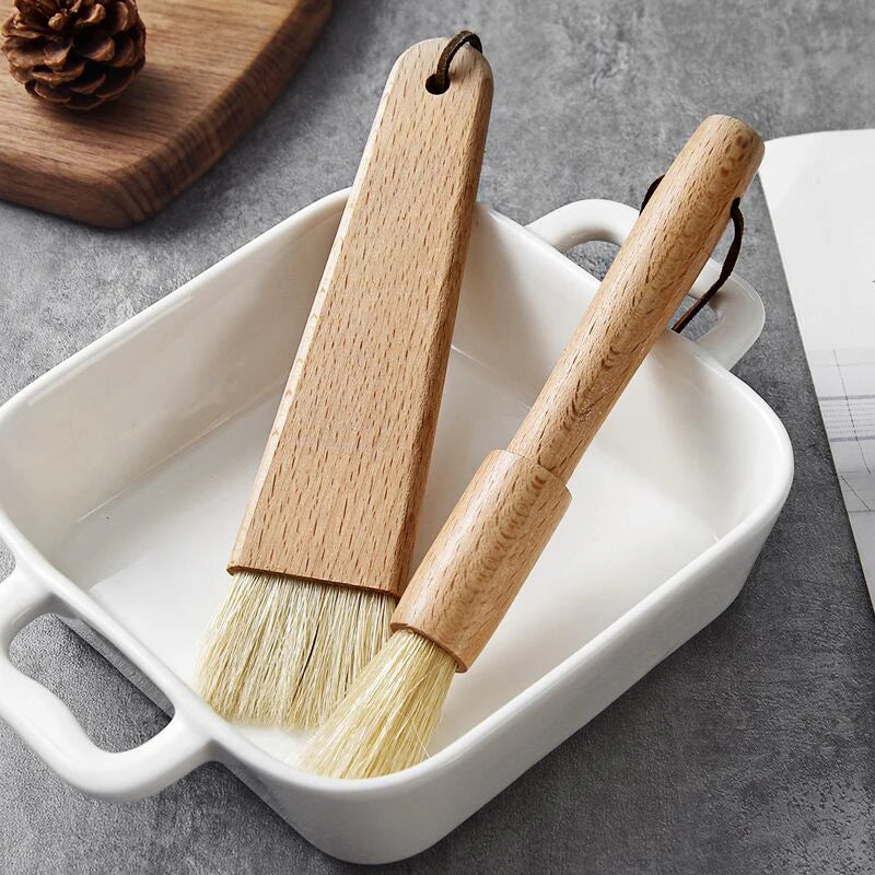 Two wooden brushes with bristle heads on a white ceramic dish against a gray background.