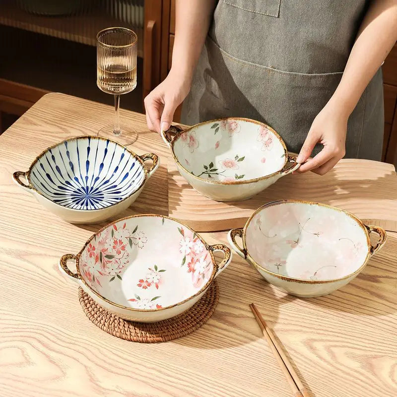 Four ceramic bowls with floral patterns on a wooden table.