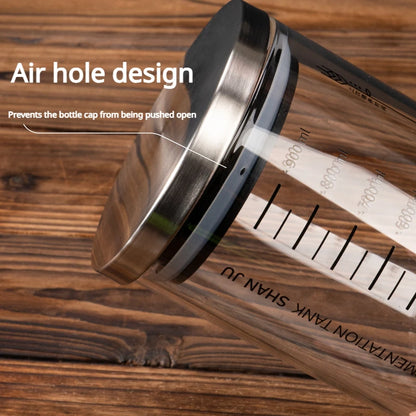 Metallic bottle cap with air hole design on a wooden surface