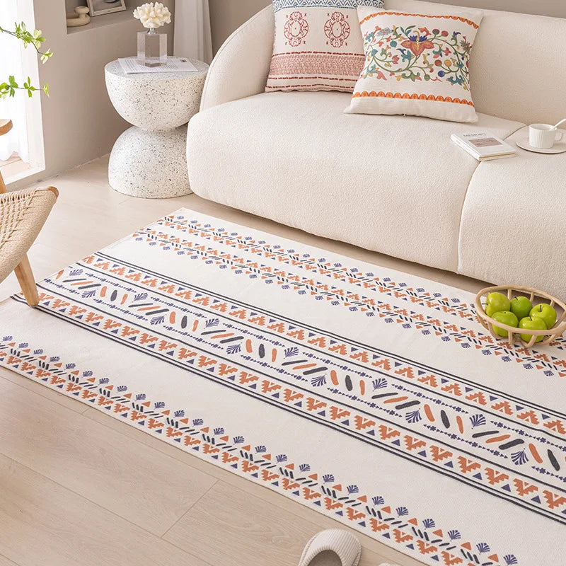 Decorative rug with floral pattern on a wooden floor in a living room setting.