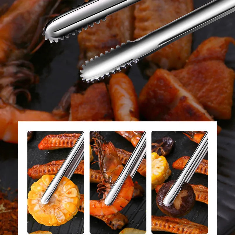 Metal tongs being used to handle cooked seafood and vegetables on a grill.