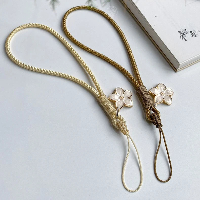 Decorative lanyard with floral ends on a light background