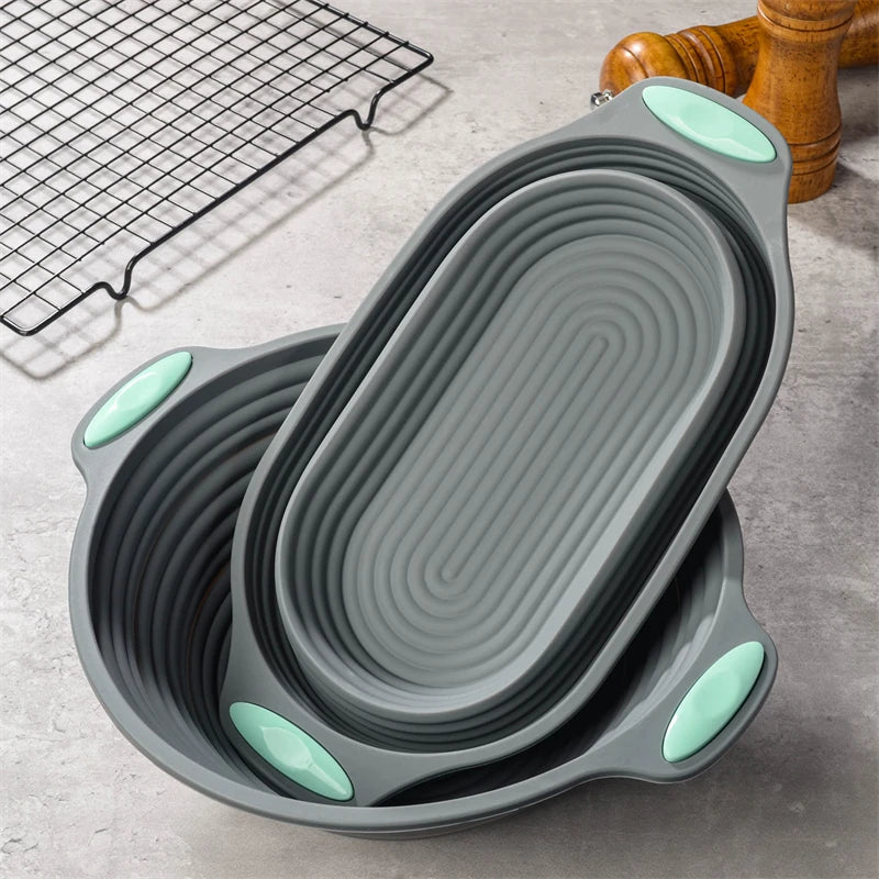 Collapsible gray silicone bowls with green accents on a kitchen counter.