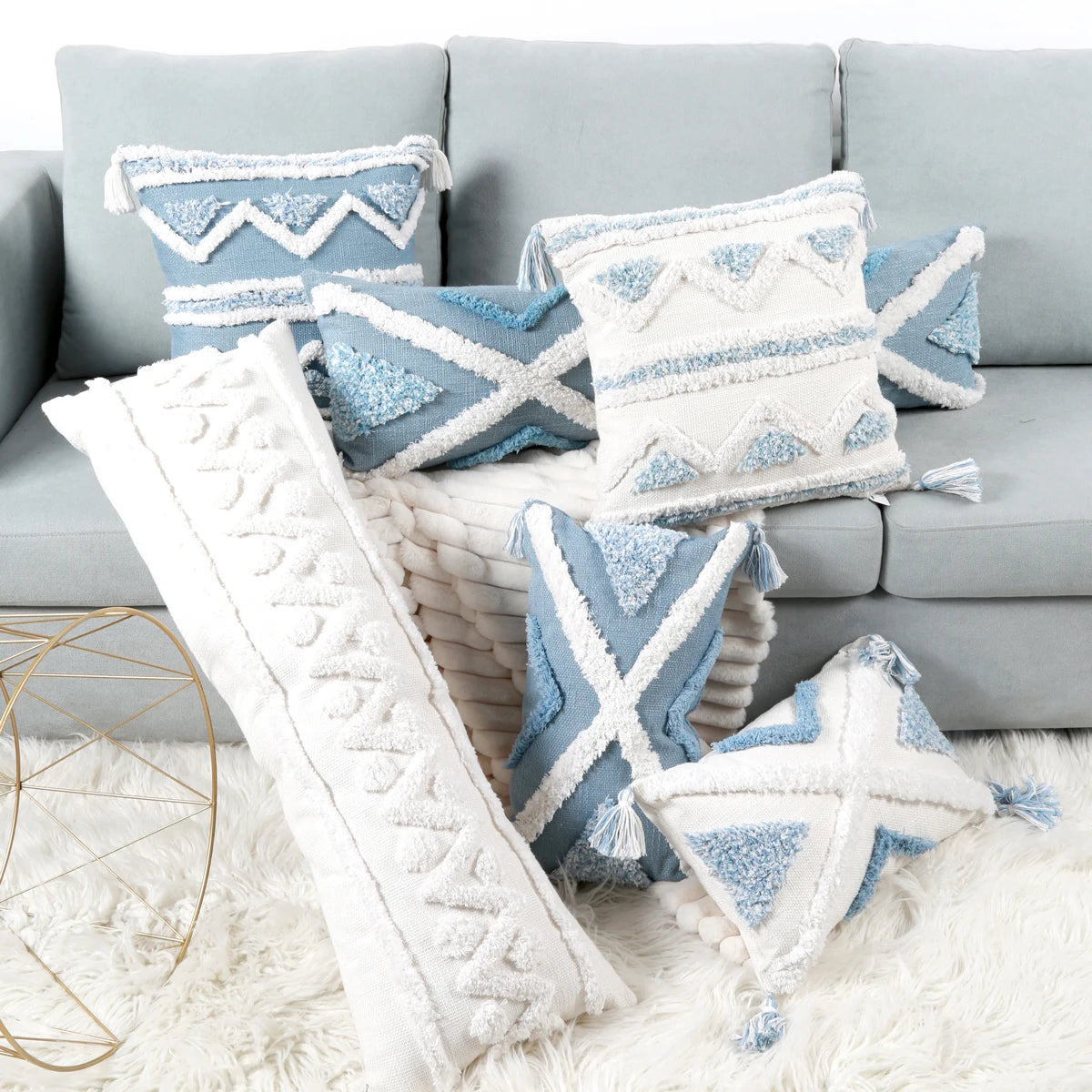 Decorative pillows with geometric patterns on a gray sofa.