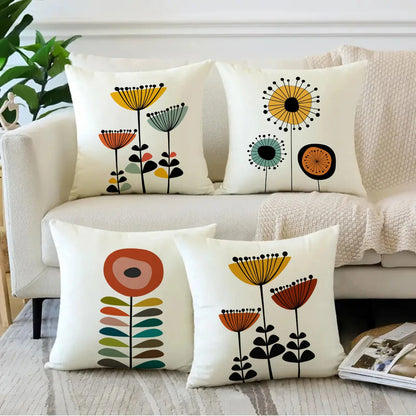 Decorative pillows with floral patterns on a couch in a living room setting.