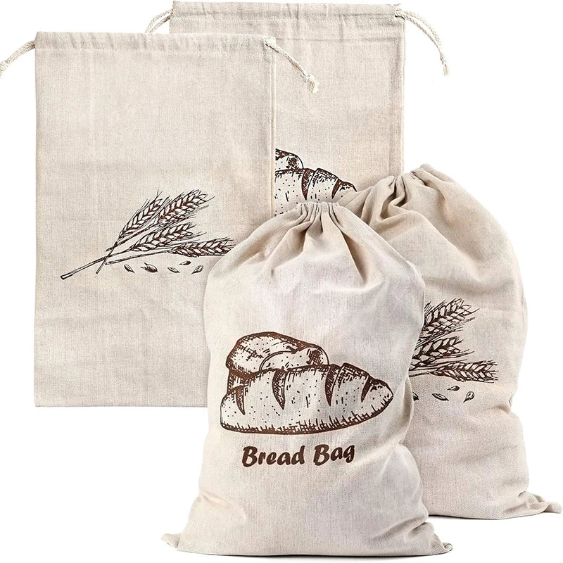 Set of three natural fabric bread bags with printed designs on a white background