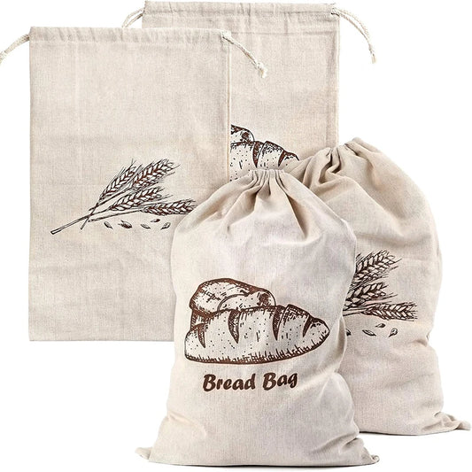 Set of three natural fabric bread bags with printed designs on a white background