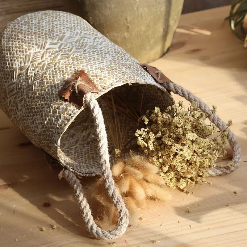 Textured bag with dried flowers on a wooden surface