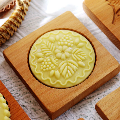 Decorative soap with floral design on a wooden coaster