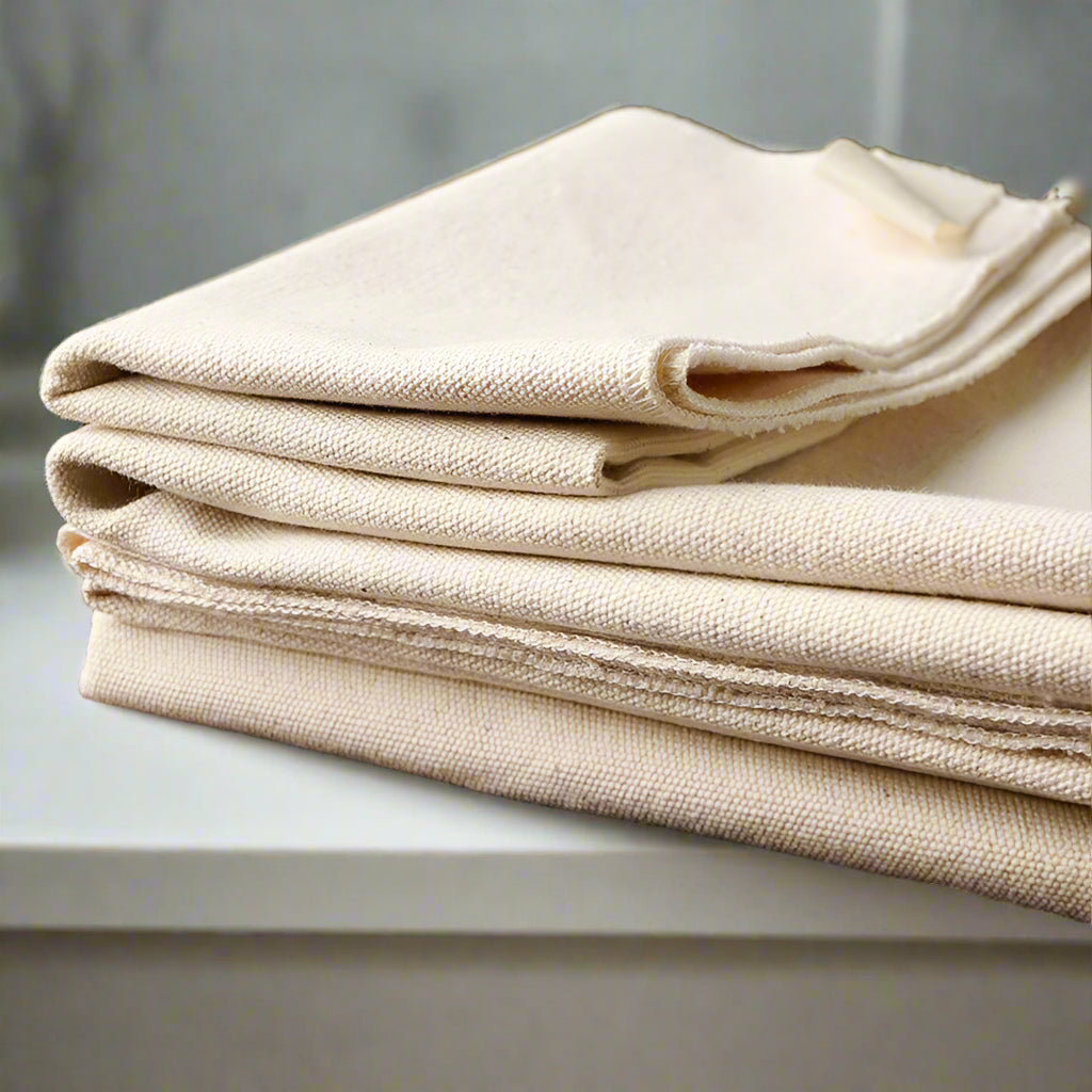 Stack of beige fabric on a wooden surface