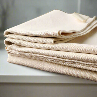 Stack of beige fabric on a wooden surface