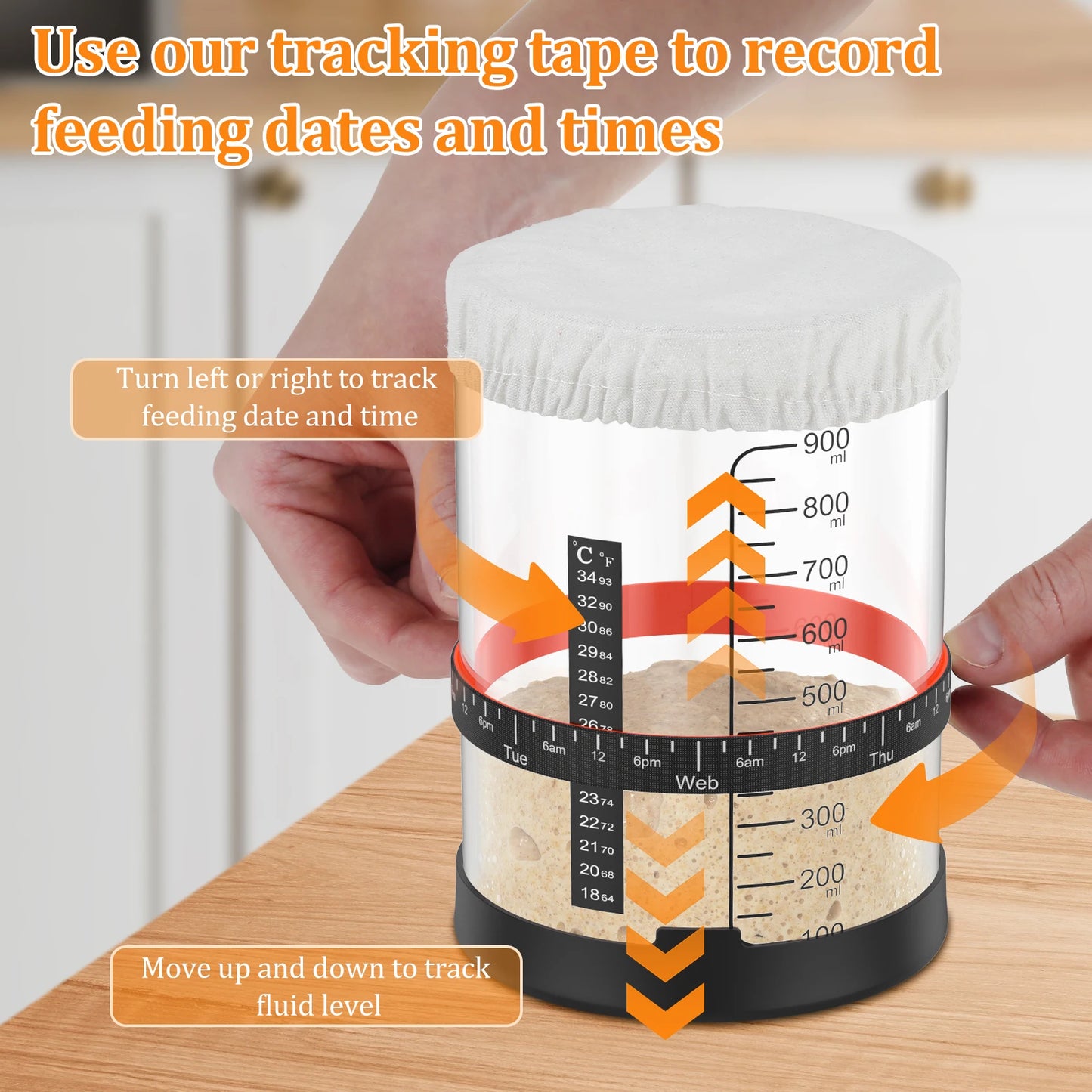 Tracking tape roll with measurement markings held by a hand on a wooden surface.