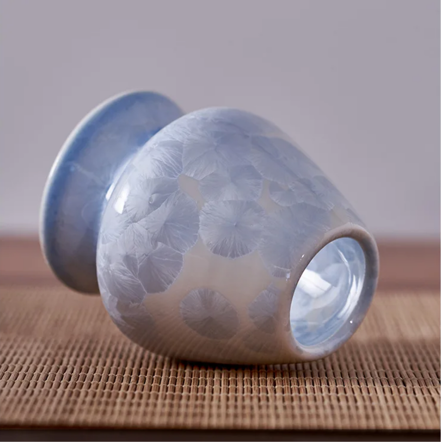 Ceramic cup with textured surface on a wooden surface