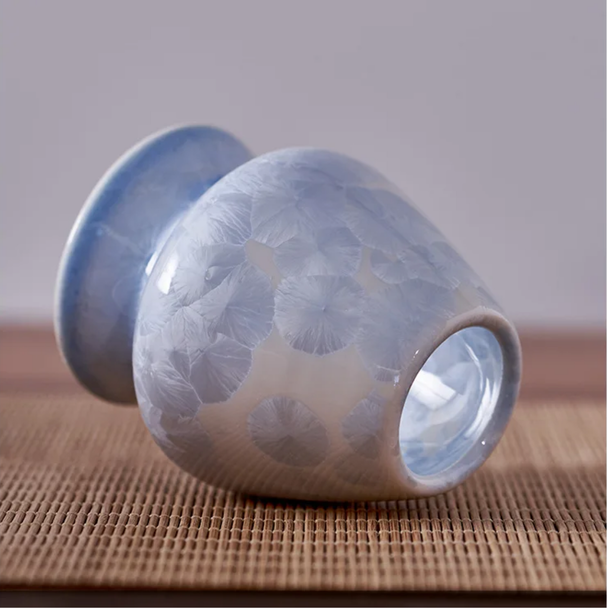 Ceramic cup with textured surface on a wooden surface
