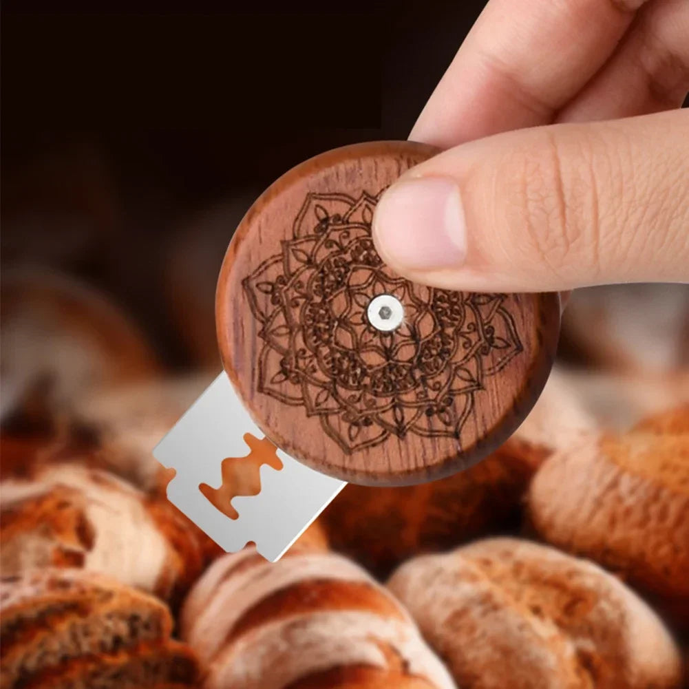 Wooden stamp with intricate design held by a hand over a pile of nuts.