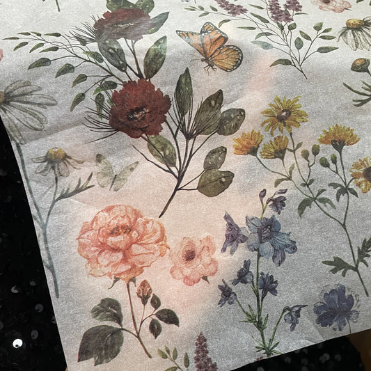 Floral pattern with flowers and a butterfly on a textured surface