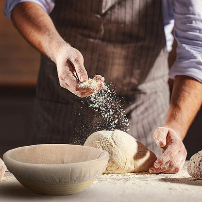 Person kneading dough with flour in a rustic setting