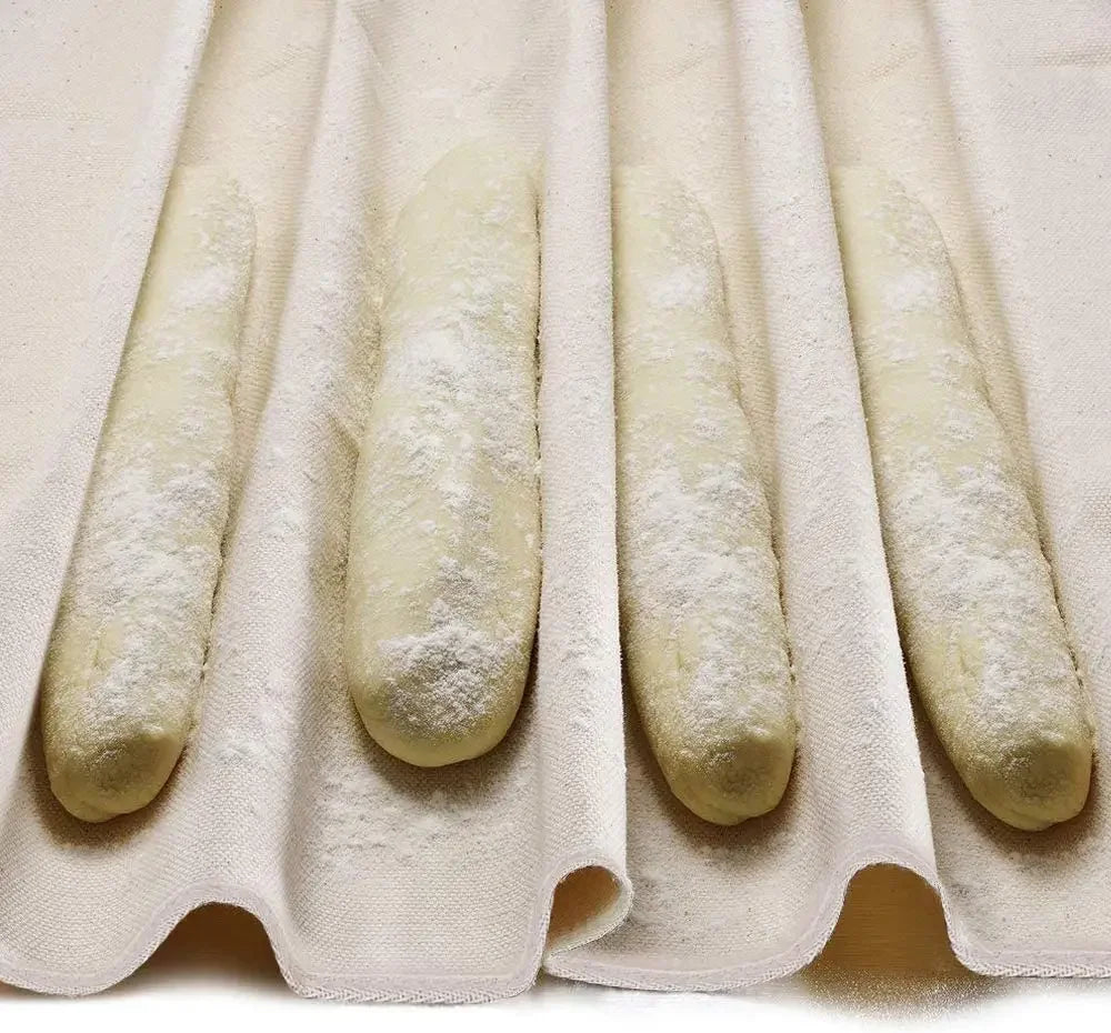 Row of bread sticks on a textured white surface