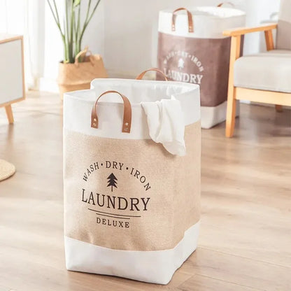 Laundry bag with 'Wash Dry Iron Laundry Deluxe' text on a wooden floor.