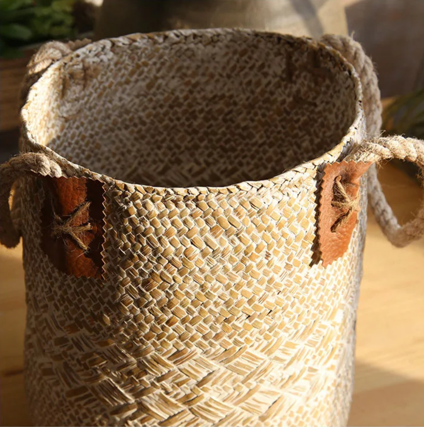 Woven basket with decorative handles on a blurred background
