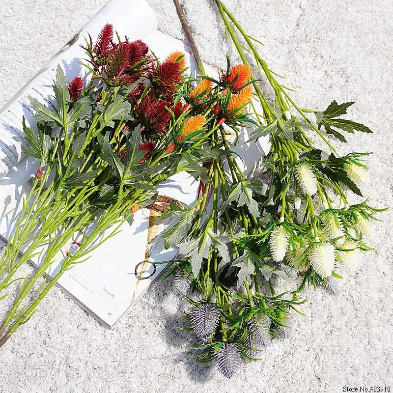 Assorted artificial flowers on a textured surface