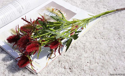 Bouquet of red and green flowers on an open book with a light gray background