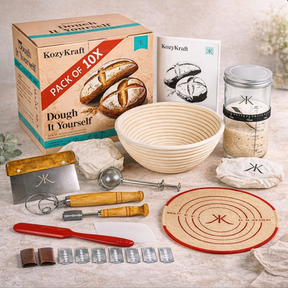 Bread-making kit with various tools and a dough basket on a light surface.