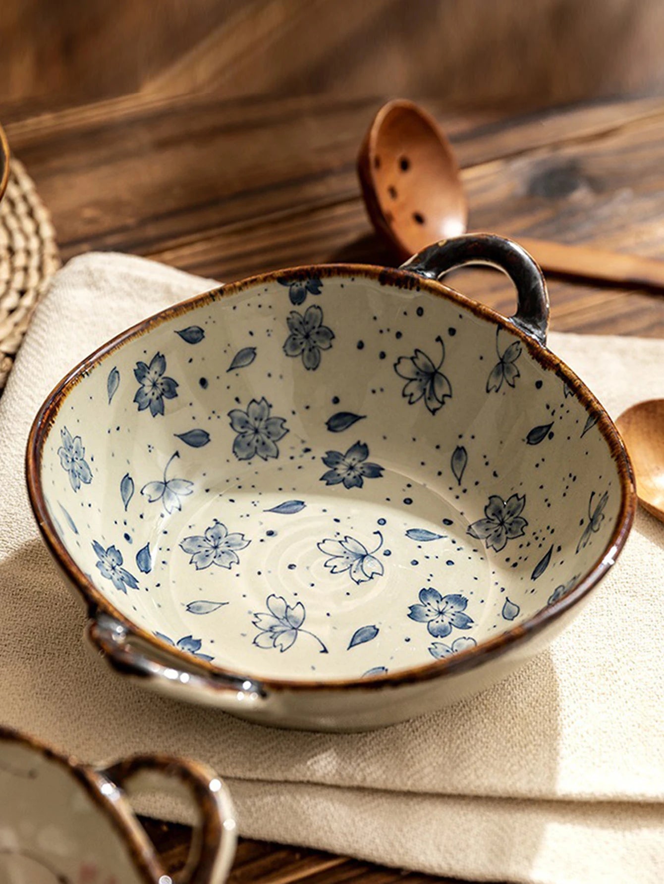 Ceramic bowl with blue floral pattern on a wooden surface