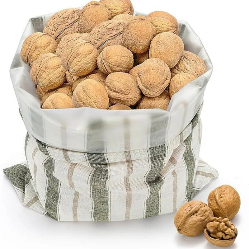 Basket of walnuts with a striped cloth cover on a white background