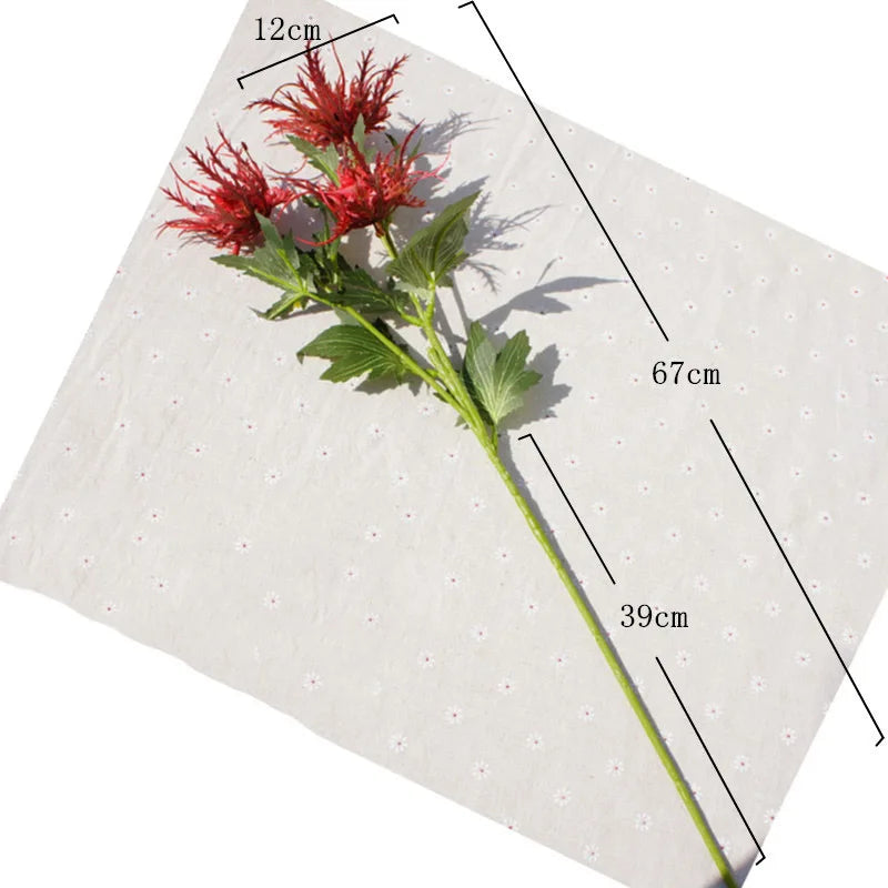 Red artificial flower with measurements on a white background