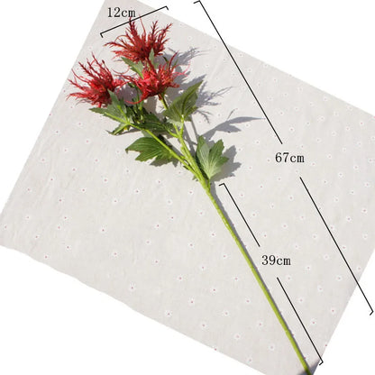 Red artificial flower with measurements on a white background