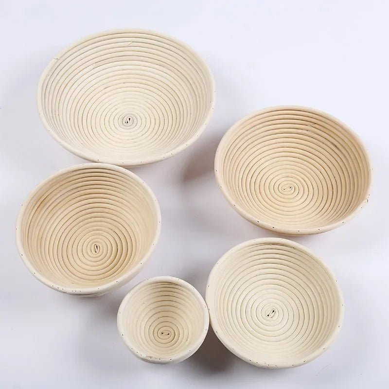 Set of five woven baskets of different sizes on a light gray background