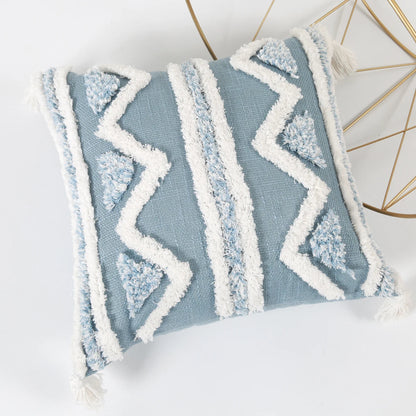 Blue pillow with white zigzag pattern on a white background