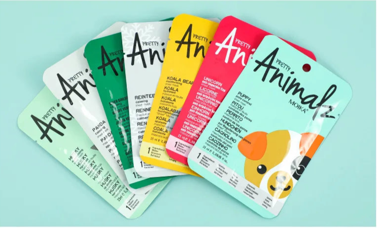 Set of colorful animal-themed face mask packages on a light blue background