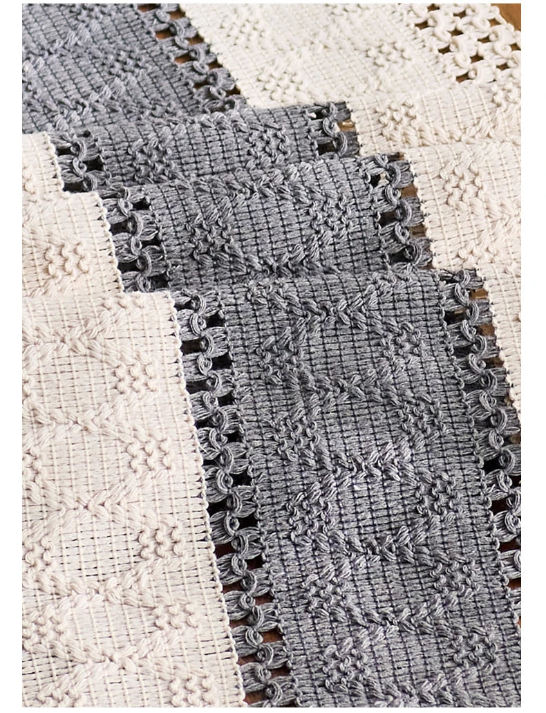 Close-up of textured fabric with a patterned edge on a white background